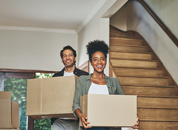 key in a door handle with moving boxes in the background representing a new home or apartment transition for two keys